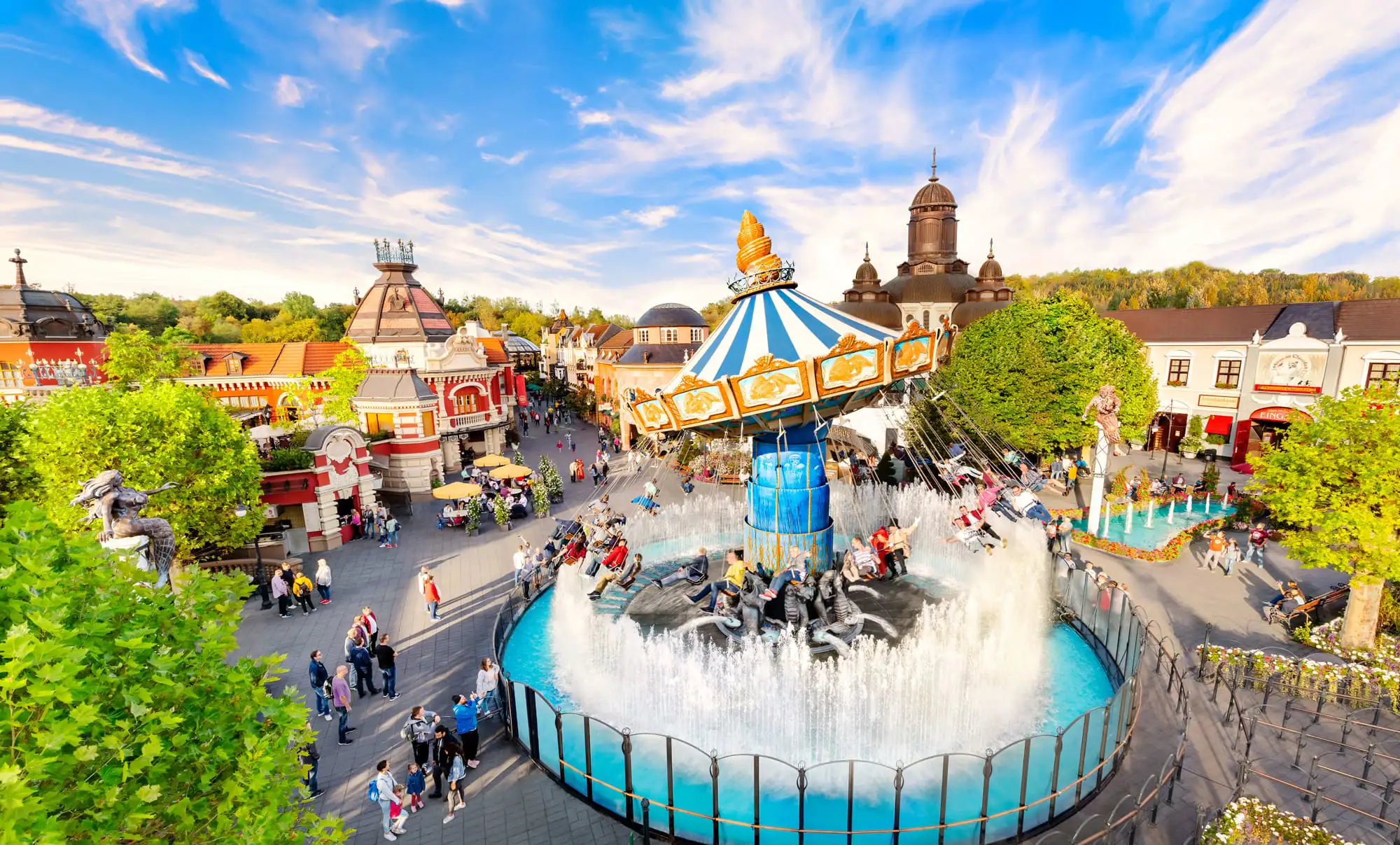 A carousel ride with a fountain below it in a theme park, Phantasialand, Germany