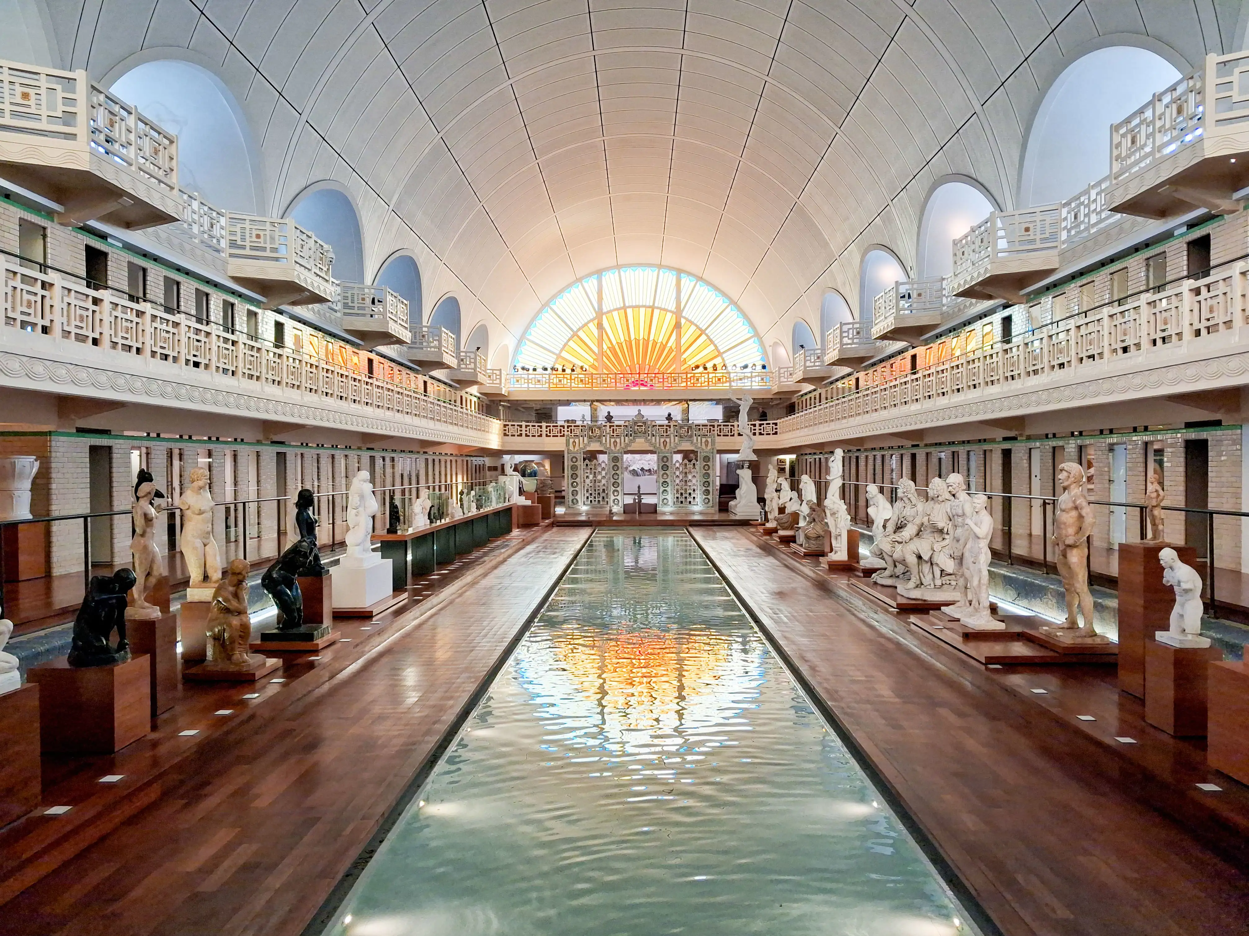 The main exhibition hall with sculptures down either side of a long pool of water, La Piscine, Roubaix