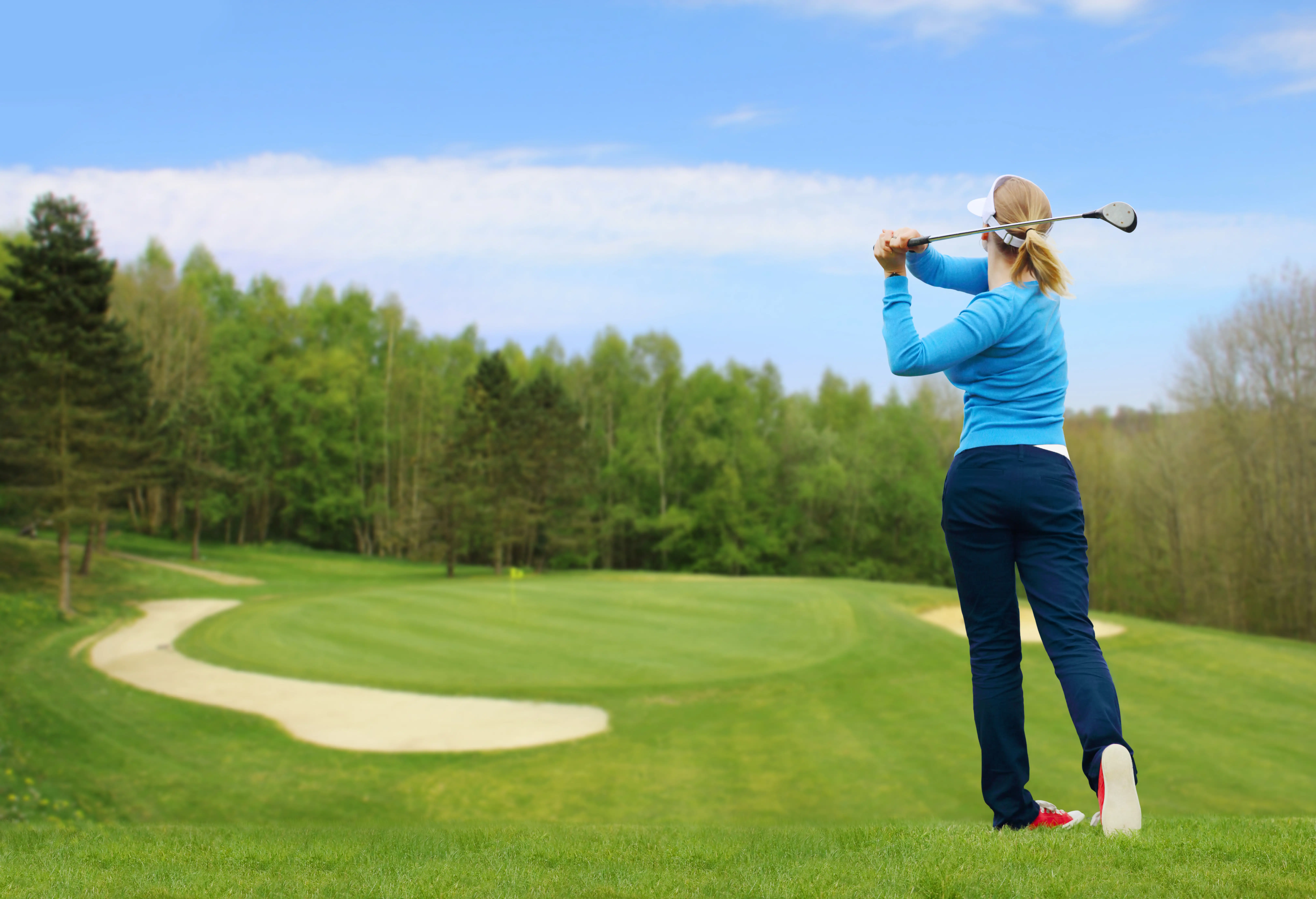 A female golfer taking a shot