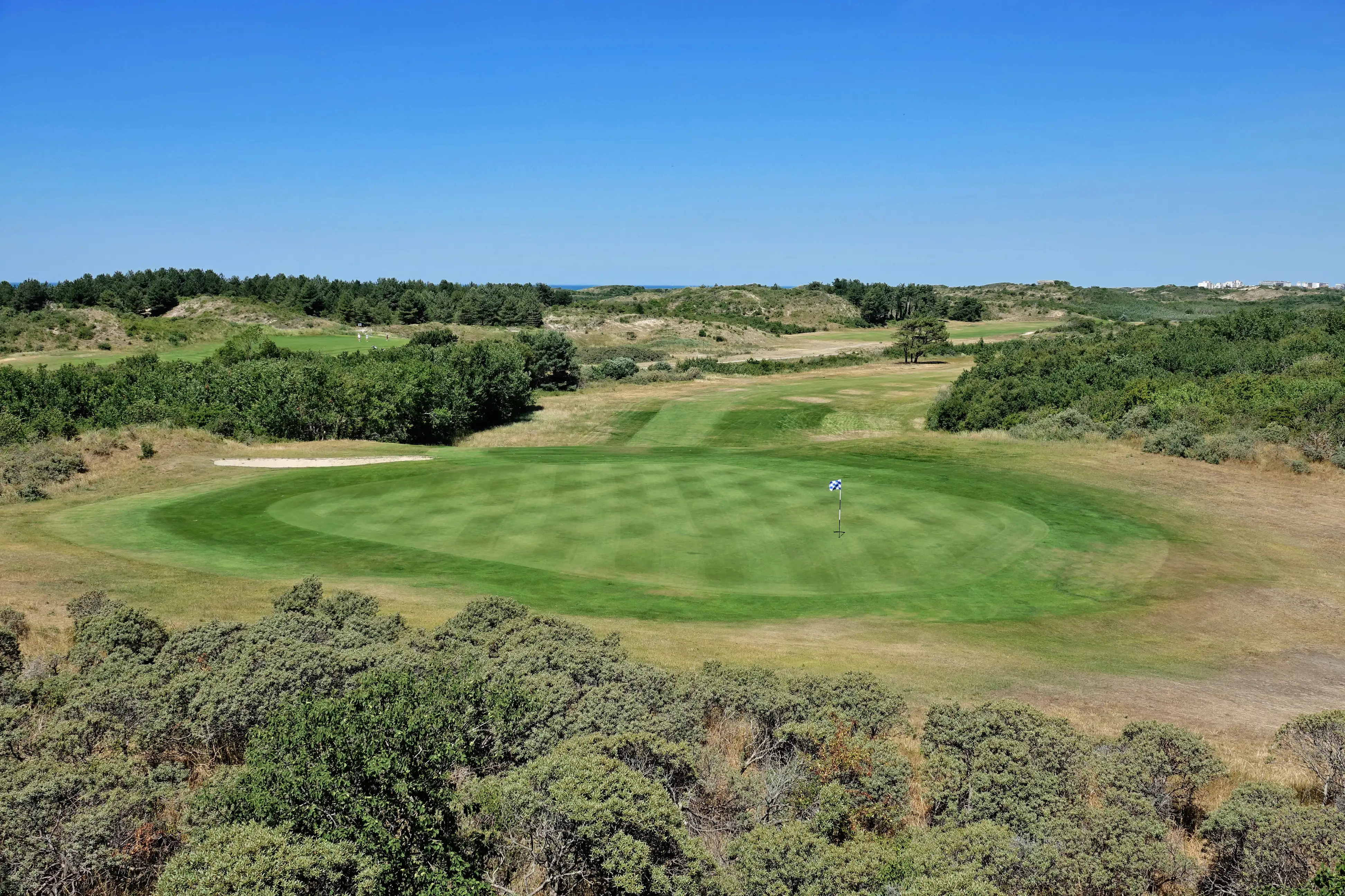 A green on a links golf course on a summer’s day