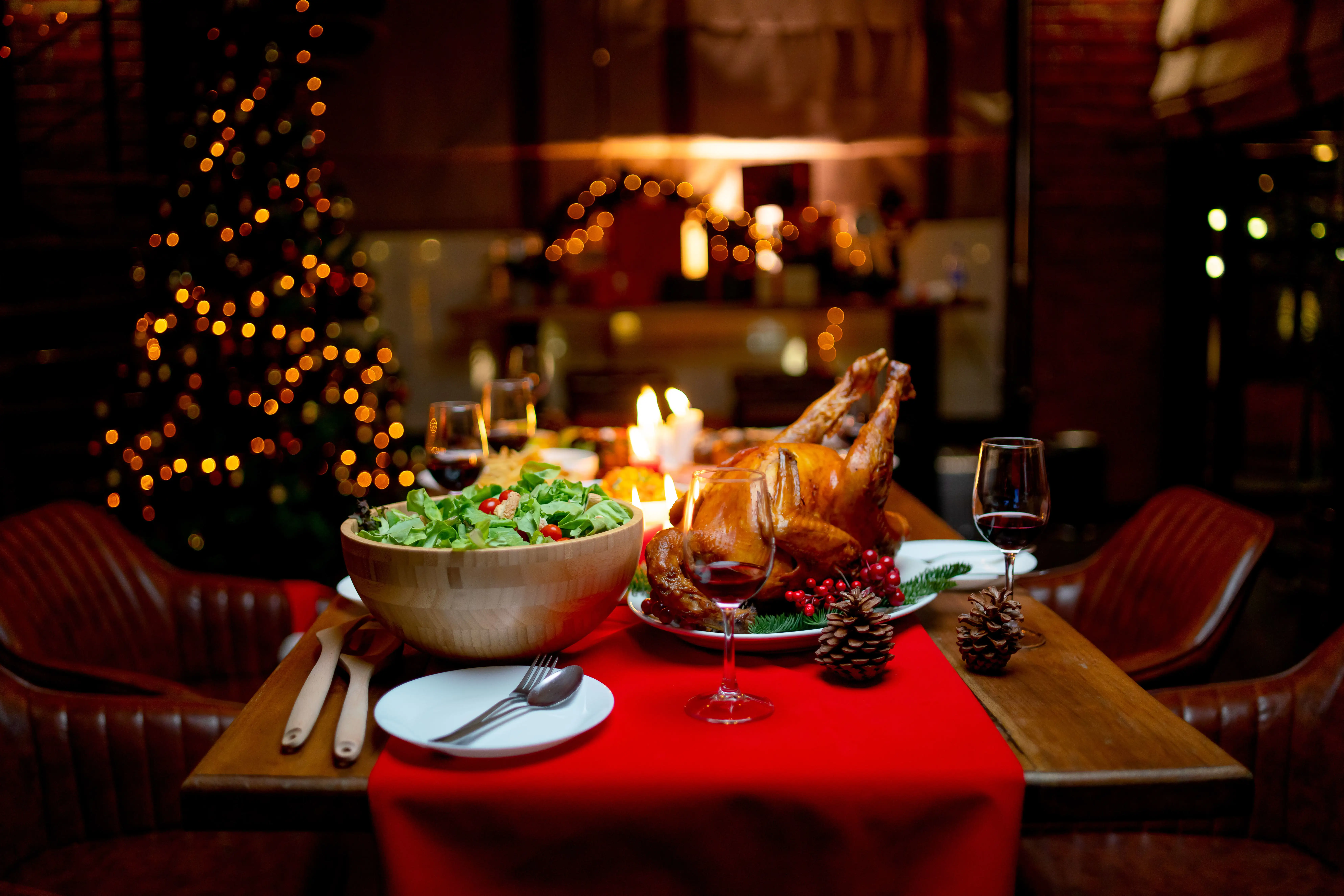 Roast turkey served on a Christmas dinner table with cosy decorations in the background