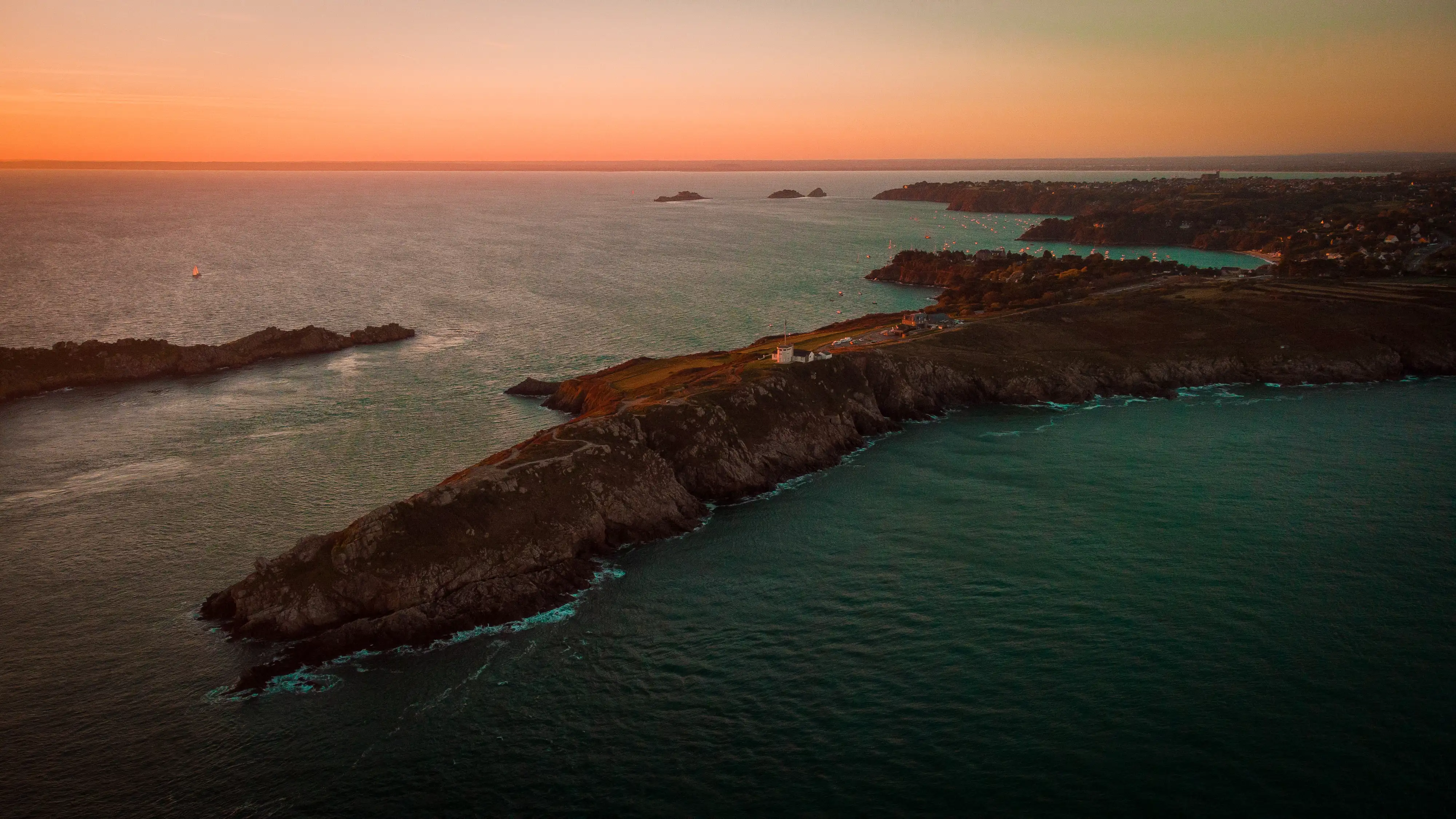 A rocky spit of land as the sun is  setting, Pointe du Grouin, France