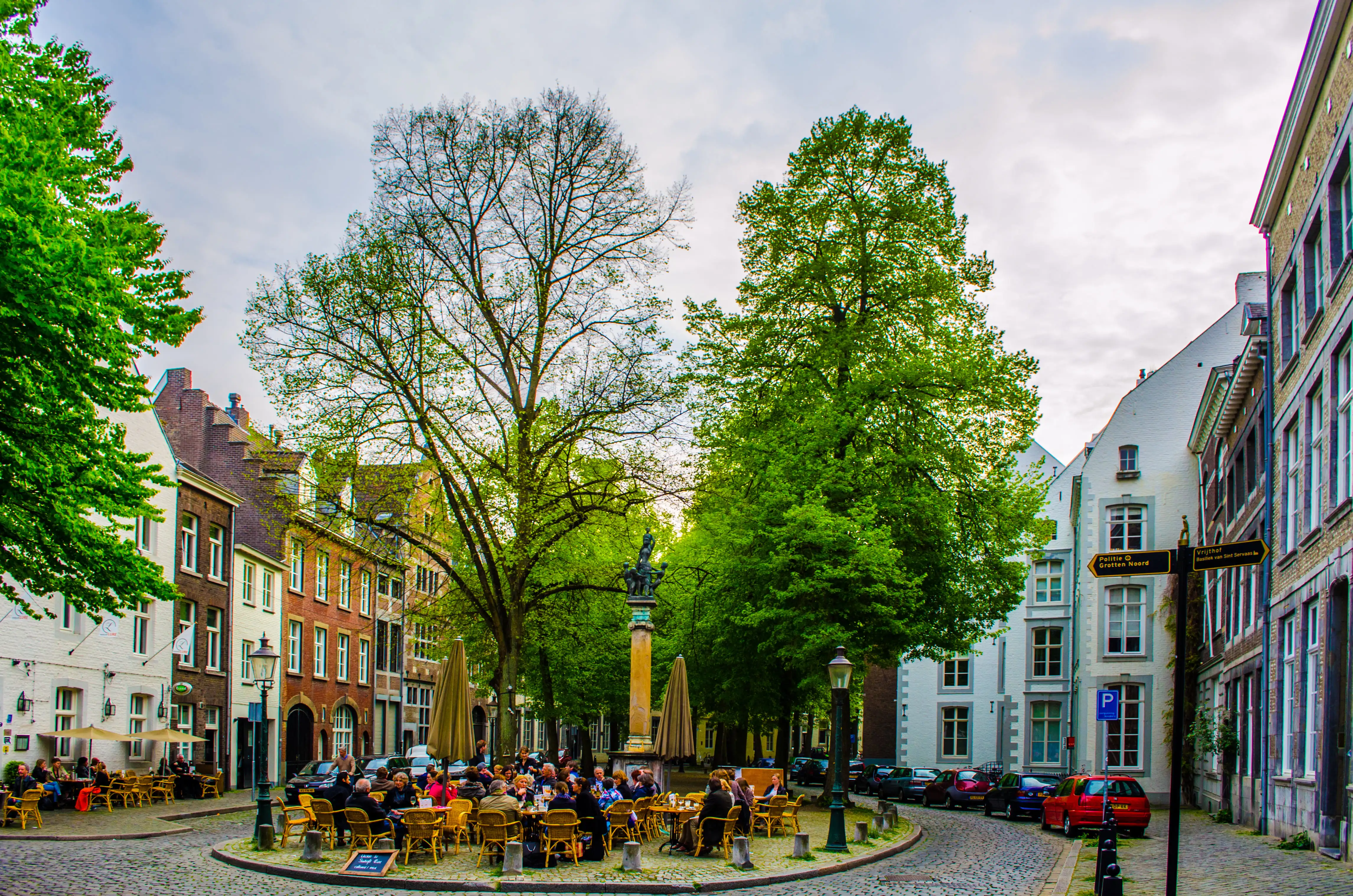 People sitting outside a café in a cobbled street in Maastricht