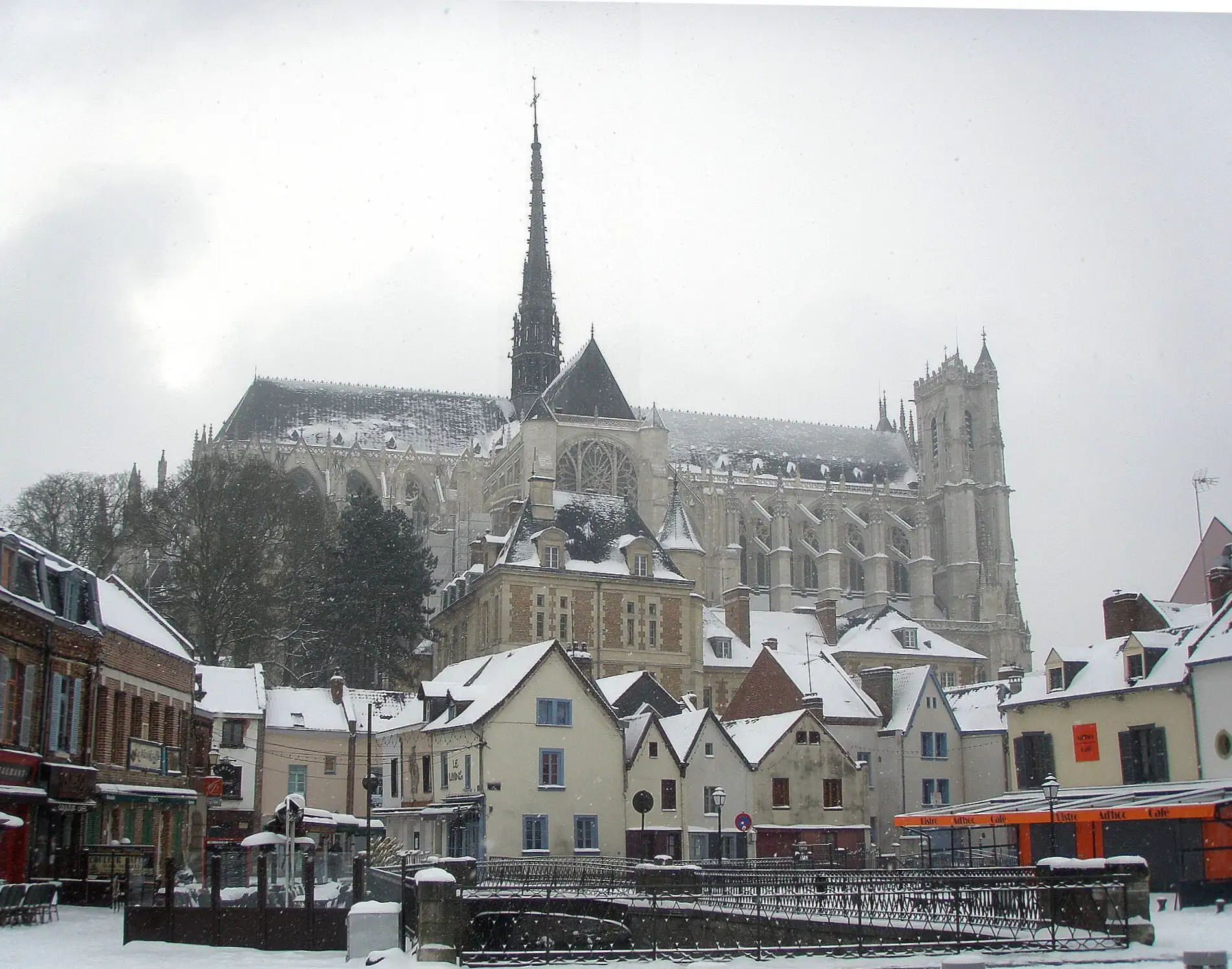 Amiens cathedral and old houses after snowfall